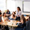 Female High School Teacher Standing Teaching Lesson in a classroom